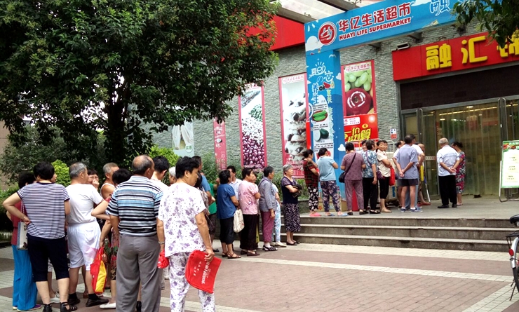 華億生活超市門前消費者排隊進入購物